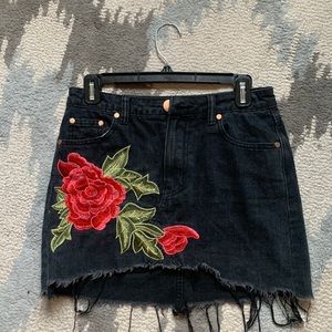 Signature brand black mini jean skirt with floral design! Size small.